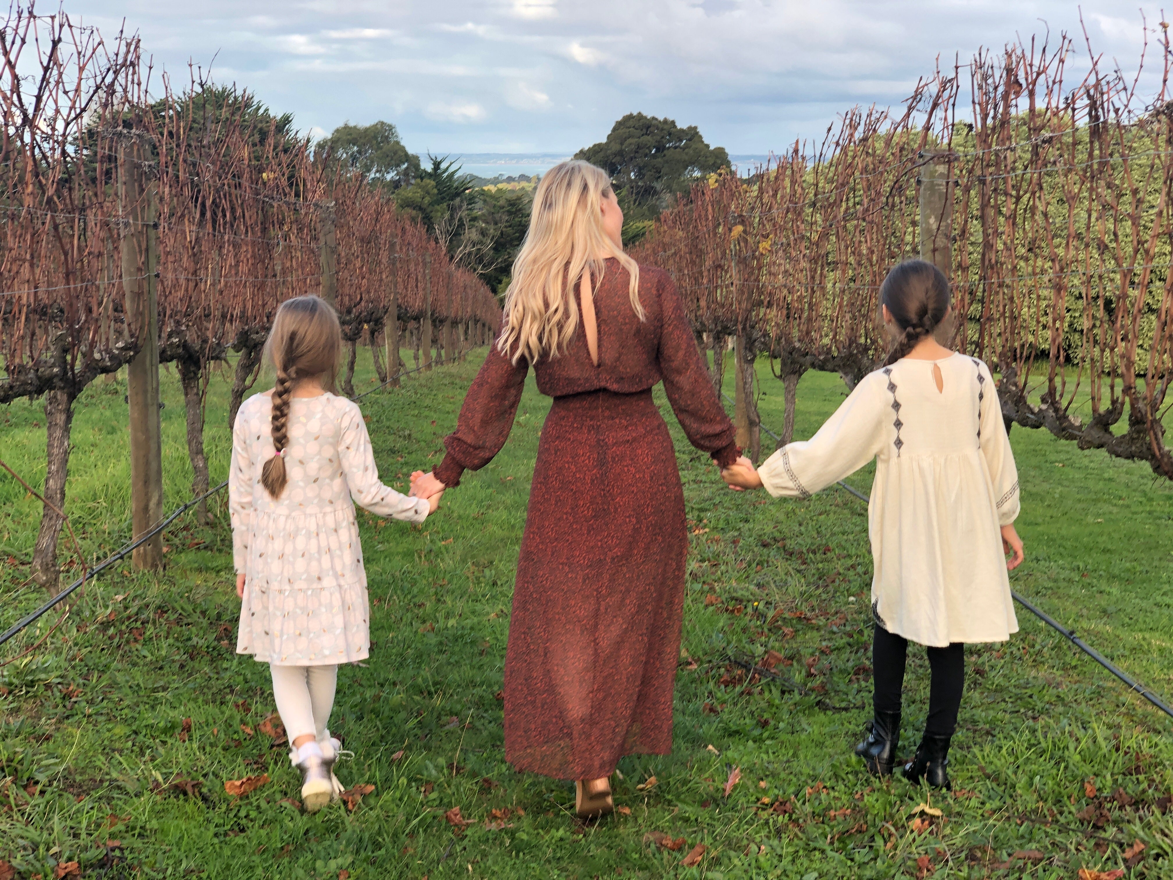 files/woman-and-children-walk-grassy-path.jpg